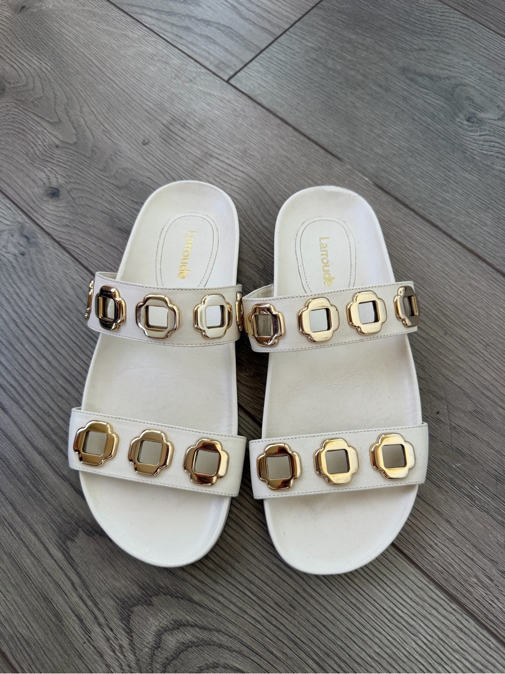 Larroude Cream Slide Sandals with Gold Emblem Accents